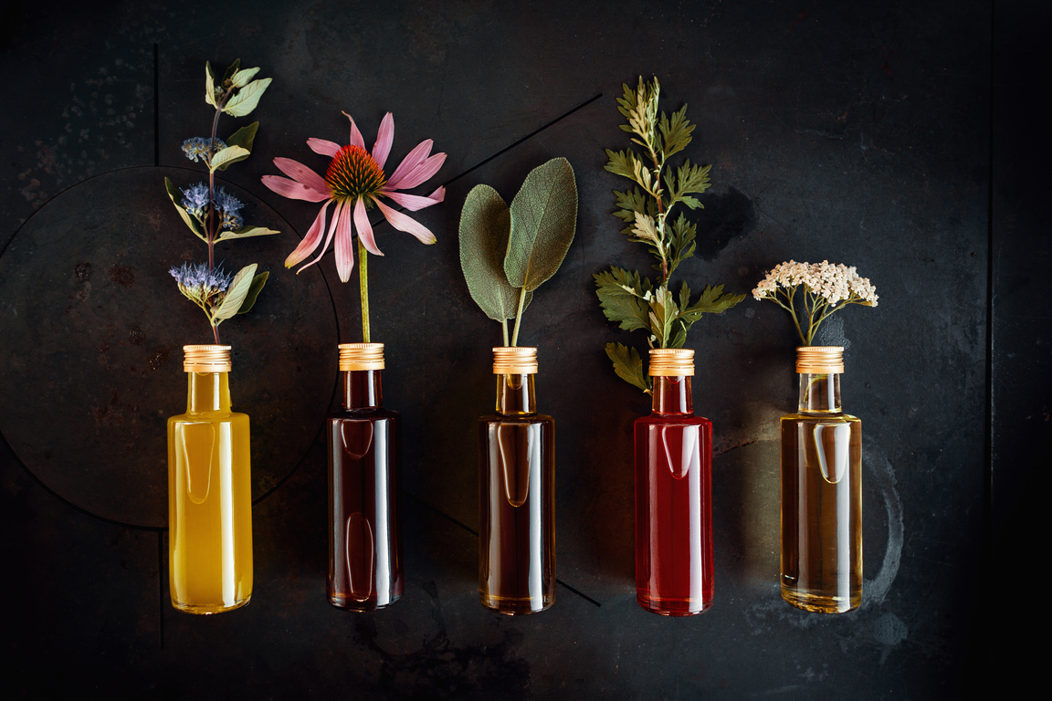 Various herbal oils with flowers